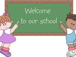 Two children holding chalk board that says welcome to our school.