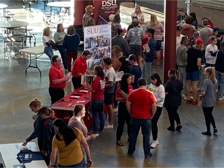 a group of students and parents talking to SUU representative  