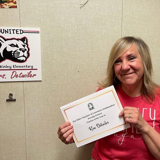 Ms. Detwiler holding certification of appreciation